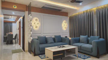 Spacious modern living room with sectional seating and designer lighting