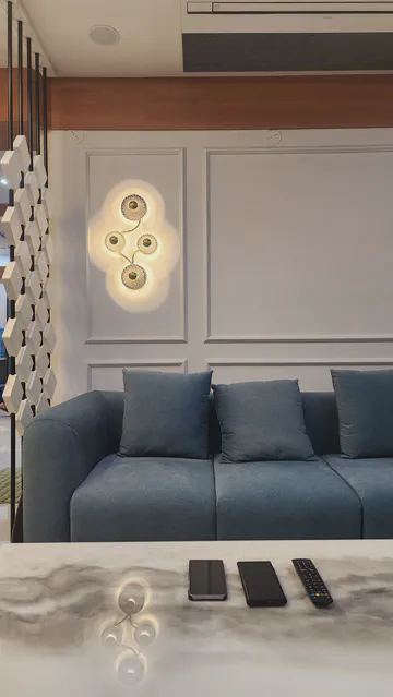 Modern living room with artistic ceiling feature and sophisticated seating arrangement