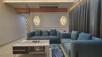 Elegant living room with custom seating and decorative wall lighting