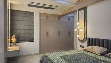 Modern master bedroom with integrated wardrobe and sophisticated lighting