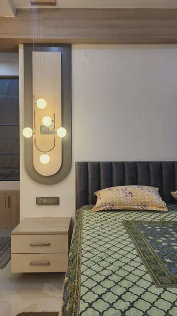 Contemporary bedroom with artistic wall treatment and modern amenities