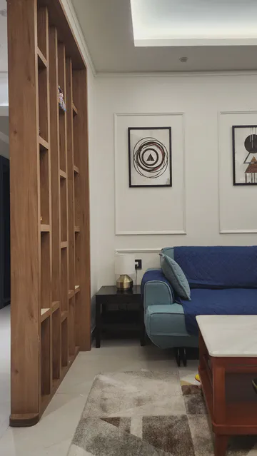 Modern living room with wooden slat divider and contemporary seating